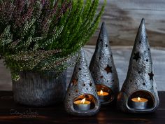 three metal candles are sitting on a table