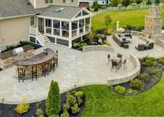 an aerial view of a patio and outdoor dining area in a large home's backyard