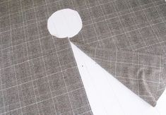 a piece of cloth with a white circle cut out of it sitting on top of a table