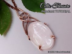 the pendant is made from wire and has a white stone