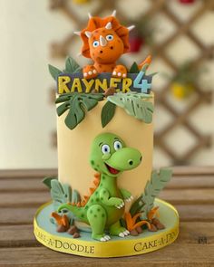 a birthday cake with an image of a dinosaur on top