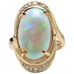 5.35 Carats Natural Impressive Ethiopian Opal and Diamond 14K Solid Yellow Gold Ring The opal has beautiful fire, pictures don't show the whole beauty of the opal! Total Natural Opal Weight is: 5.00 Carats Opal Measures: 17.88x 11.20mm Total Natural Round Diamonds Weight: .35 Carats (color G-H / Clarity SI1-SI2) Ring size: 6.5 (free re-sizing available) Ring total weight: 9.3 grams Disclaimer: all weights, measurements and colors are approximate and may vary slightly from the listed dimensions o Opal Diamond Engagement Ring, Fire Pictures, Yellow Gold Cocktail Ring, Ethiopian Opal Ring, Fire Opal Ring, Gold Statement Ring, Gold Cocktail Ring, Yellow Gold Engagement Rings, Pretty Rings