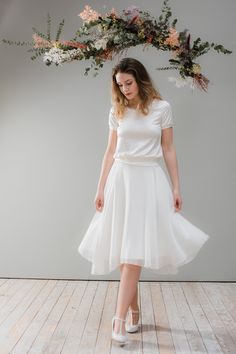 This light, fluttery chiffon skirt has an asymmetrical cut and conjures up a flower-like glockenspiel. It is underlaid with solid romanite jersey and ends at the waist with an elastic rubber in satin wrapped in satin. This enchanting chiffon skirt can be combined with many of the Ave evA bridal tops or bridal bodies. As a special highlight, you can finish the look with one of the bridal belts. Here the skirt is combined with the top satin. Length of underskirt approx.: 60 cm Material Specificati Fitted Sheer Chiffon Skirt, Summer Wedding Silk Skirt, Silk Wedding Skirt For Summer, White Flowy Draped Skirt For Evening, Fitted Chiffon Skirt For Wedding, Chiffon Fitted Wedding Skirt, Fitted Chiffon Wedding Skirt, Chiffon Wedding Skirt Fitted, Top Satin