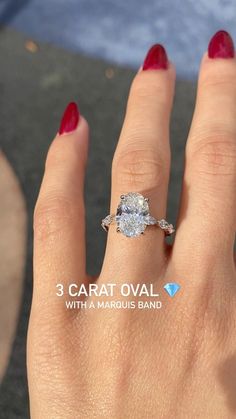 a woman's hand with a diamond ring on it and the words carat oval