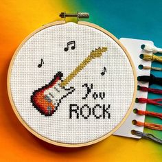 a cross - stitch pattern with the words do you rock on it next to some scissors