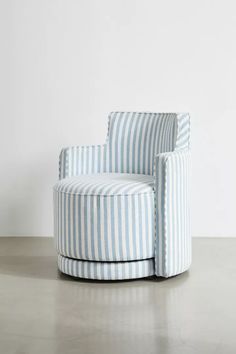 a blue and white striped chair sitting on top of a cement floor