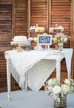 a white table topped with cakes and cupcakes