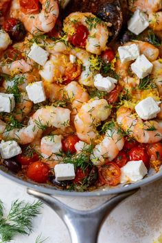 shrimp, tomatoes and feta cheese in a skillet