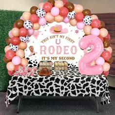 this is an image of a pink and brown balloon arch for a 2nd birthday party