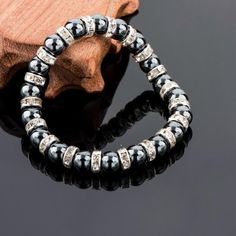 For a sparkling, yet understated addition to your collection, discover this strikingly beautiful Tibetan Silver Black Beaded Bracelet. Taking inspiration from the classic beaded bracelet, this piece features highly polished black stones spaced with Austrian Crystal bars. Providing an exceptional contrast and a stunning piece for a special occasion, this bracelet stretches to accommodate most wrist sizes and has a comfortable finish making it ideal for all day wear. Makes for a Great Gift idea! Bracelet length: 19cm Black bead size: 0.7cm Elegant Adjustable Hematite Stretch Bracelet, Elegant Adjustable Hematite Crystal Bracelet, Elegant Silver Beaded Bracelets With Stones, Elegant Silver Hematite Stretch Bracelet, Magnetic Hematite Bracelet, Elegant Black Magnetic Bracelets, Silver Stretch Bracelet With Black Beads, Elegant Hematite Beaded Bracelets With Magnetic Clasp, Beaded Hematite Bracelets