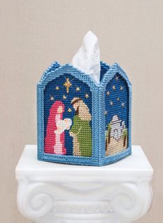 a tissue dispenser with a nativity scene on it