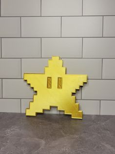 a yellow object sitting on top of a counter next to a brick wall in a room