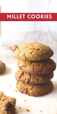 a stack of cookies sitting on top of a white table next to a glass of milk