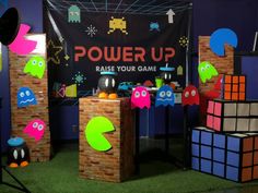 a room with some toys on display and a sign that says power up raise your game