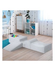 a child's playroom with white furniture and blue rugs on the floor