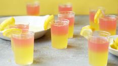 several glasses filled with drinks and lemon wedges