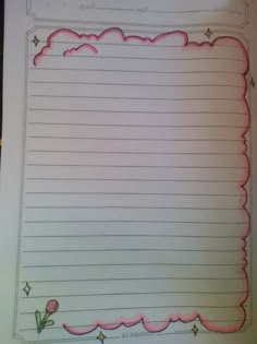 an open notebook with lined paper and flowers on the page, which has been drawn in pink