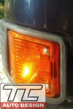 the tail light of a car with an auto design sticker on it