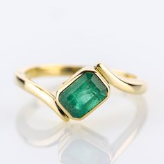 A piece from our collection, featuring a natural emerald of 1,28 carats set into a timeless yellow gold design.   Metal 14k / 0.585 gold Gemstones 1 emerald 1.28ct Measurements Head 10.0mm Shank 2.1mm Ring size 7 US Weight 3.6g Condition New General Information All items come with certificate of authenticity, gemstones have been tested at our lab if not otherwise indicated. Pendants are shown with chain for decorational reasons, please note that they do not come with a chain. Payment We accept p 14k Gold Emerald Cut Emerald Ring For May Birthstone, Emerald Cut Ruby Ring In Yellow Gold, Emerald Ring In Yellow Gold, Fine Jewelry Yellow Gold Emerald Ring For May Birthstone, Gold Emerald Cut Birthstone Ring, Yellow Gold Emerald Birthstone Ring For May, Emerald Yellow Gold Birthstone Ring For May, Gold Solitaire Emerald Cut Emerald Ring, 14k Yellow Gold Emerald-cut Ring