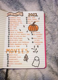 an open notebook with the words movies written in orange and black on it, sitting on a furry surface