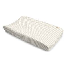 the baby pillow is white and has a ribbed pattern on it's side