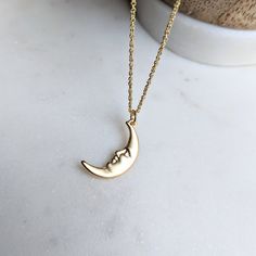 Man in the Moon Face Necklace 🌛 The detailed pendant is made of brass and then plated in high quality matte gold. The chain is stainless steel, which means it is hypoallergenic, tarnish resistant, and rust proof 😊 Just choose the length you would like before checkout 🌒 This comes in either silver or gold, just choose in the options box 💛 I have so many celestial items in my shop, this looks so good layered with my other items! I pair it with my gold labradorite choker ✨ Hope you're finding s Gold Moon Charm Necklaces, Gold Moon Phase Charm Necklace, Crescent Moon Phase Brass Necklace, Brass Crescent Moon Phase Necklace, Gold Charm Necklace With Moon Phase, Gold Half Moon Charm Necklace, Gold Half Moon Charm Necklace With Moon Phase, Moon Shaped Brass Necklace With Moon Charm, Brass Moon-shaped Necklace With Moon Charm