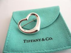 Overview:Offered for sale is a wonderful Tiffany and Co. Silver Peretti Open Heart Brooch/Pin.   The piece is made from substantial Tiffany silver formed into Peretti's classic Open Heart Heart shape.  In very good condition, this piece is one that you will turn to very often to jazz up your wardrobe.  It is no longer produced, and thus makes a great addition for any Tiffany collector.   The piece has a perfectly working locking mechanism, and is fully hallmarked.Everyone needs a Signature Ti Elegant Silver Heart-shaped Brooch, Elegant Silver Heart-shaped Brooches, Elegant Silver Heart Brooch, Elegant Silver Heart Brooches, Elegant Heart-shaped Wedding Brooch, Classic Love, Rare Gifts, Heart Pin, Breakfast At Tiffany's