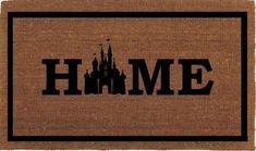 a door mat with the word home in front of a castle on top of it