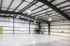 an empty warehouse with white walls and floors