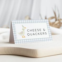 a place card sitting on top of a cutting board with deer antlers in the background