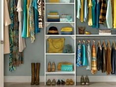 an organized closet with clothes, shoes and handbags on the shelves in front of it