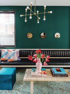 a living room filled with furniture and a green wall