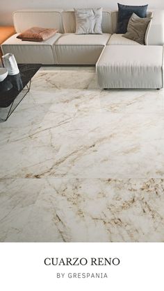 a living room with marble flooring and white couches in it's center