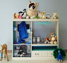 there is a shelf with stuffed animals on it and other toys in front of it