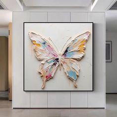 a large butterfly is hanging on the wall