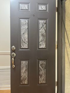 a black door with three glass panels on it