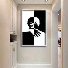 a white and black painting hanging on the wall