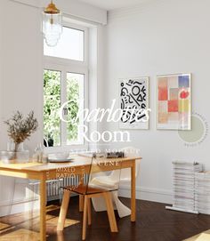 a table and chairs in a room with white walls, wood floors and windows on the wall