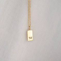 "Personalized Gold Rectangle Pendant Necklace from our Memoirs Made Collection. Personalize a short word or up to three initials on the lovely 14k gold filled tag necklace Free Engraving for a limited time! NECKLACE DETAILS ⚬ 14k gold-filled rectangle and chain. ⚬ Chain in your choice of 16\", 18\", or 20\" length ⚬ Rectangle measures 13.5mm x 6mm (.53\" x .23\"). ⚬ Spring ring clasp closure. ⚬ Personalized engraving of 1-3 characters (including spaces); ⚬ Choice of 3 fonts for the engraving. ⚬ Classic Name Necklace For Birthday, Gold Nameplate Charm Necklace For Birthday, Everyday Gold Nameplate Charm Necklaces, Everyday Gold Nameplate Charm Necklace, Classic Yellow Gold Name Necklace For Birthday Gift, Classic Tarnish Resistant Name Necklace For Anniversary, Classic Tarnish-resistant Name Necklace For Anniversary, Everyday Gold Nameplate Necklace, Gold Sterling Silver Initial Necklace For Birthday