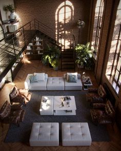 an aerial view of a living room with couches and chairs, coffee table and stairs