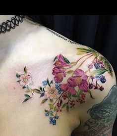 a woman's chest with flowers and birds on it