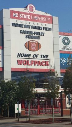 a large sign on the side of a building that says, home of the wolfpack