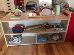 a child's playroom with toys and other items on the shelf in front of it