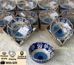 small blue and white dishes with tags tied in twine on top of each other