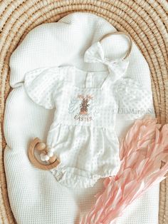 "Welcome to our enchanting Easter collection!  This darling white tulle gingham bubble romper is the epitome of charm and sweetness for your little one's first Easter celebration. Adorned with delicate details, it even includes a matching bow headband.  Crafted with comfort in mind, the romper features an elasticized design for easy movement, while the sash in the back allows for a customizable fit and a delightful bow accent. Three buttons on the back add a touch of vintage flair and ensure effortless dressing. \"My First Easter\" is delicately embroidered on the chest, making this romper a cherished keepsake for years to come. Perfect for Easter egg hunts, family gatherings, or simply capturing precious moments, this romper promises to make your little one shine. Embrace the joy of Easte Cute Gingham Bubble Romper For Spring, Cute Spring Gingham Bubble Romper, White Sweet Bubble Romper For Spring, Sweet White Bubble Romper For Spring, Spring Gingham Bubble Romper With Ruffles, White Bubble Romper For Spring, White Short Sleeve Bubble Romper For Baptism, Cute Bubble Romper For Spring Baptism, Cute Spring Bubble Romper For Baptism