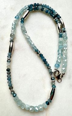 Natural Gemstone Necklace. Sterling silver clasp and silver plated pewter large accent beads. Aquamarine is considered to be the stone of courage and preparedness and is believed to help maintain balance and order. Aquamarine is often used as a "good luck" stone, thought to bring feelings of peace, love, joy and happiness to those who wear it.Arrives thoughtfully packaged in an eco-friendly kraft box wrapped in ribbon, ready for gifting or keeping for yourself. Beautiful Beaded Necklaces, Natural Gemstone Necklace, Aquamarine Necklace, Aquamarine Beads, Multi Strand Bracelet, Joy And Happiness, Necklace Sterling Silver, Crystals And Gemstones, Peace Love