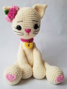 a crocheted cat sitting on top of a white table