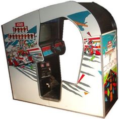 an old fashioned arcade game machine with its door open and the front panel painted white