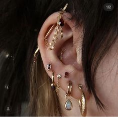 a close up of a person's ear with different types of piercings on it