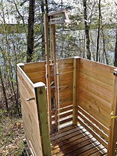 an outdoor shower in the woods with water coming from it